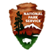 National Park Service logo featuring a brown shield with a mountain, trees, and a bison. Represents conservation and public land management.